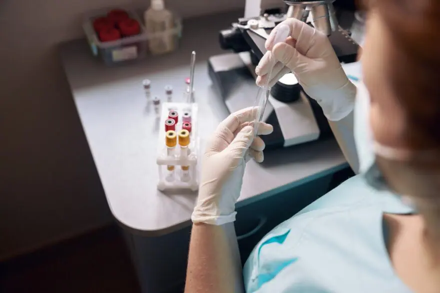 female lab tech takes sample from test tube to res 2022 01 19 00 01 33 utc